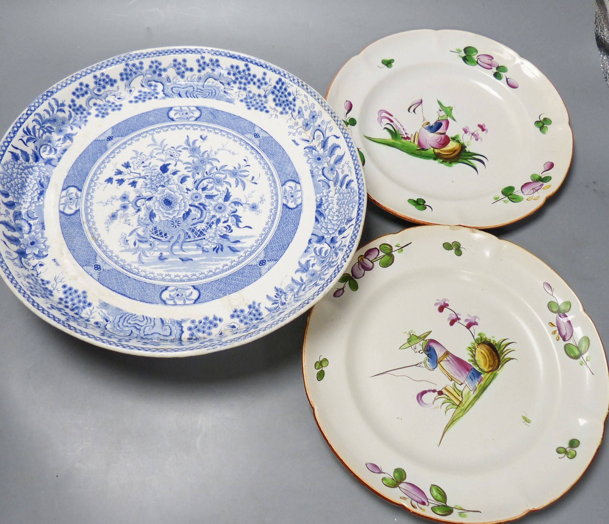 An ironstone cheese stand and a pair of French faience plates 30cm